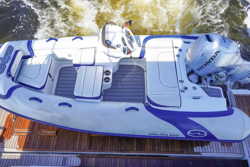 Slide: The Image of 2017 Azimut 66 Flybridge with Walker Bay tender and Honda outboard engine. - 62
