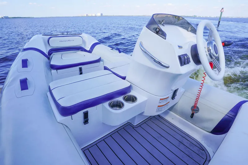 Slide: The Image of 2017 Azimut 66 Flybridge boat interior with white and purple seating, steering wheel, and cup holders. - 64