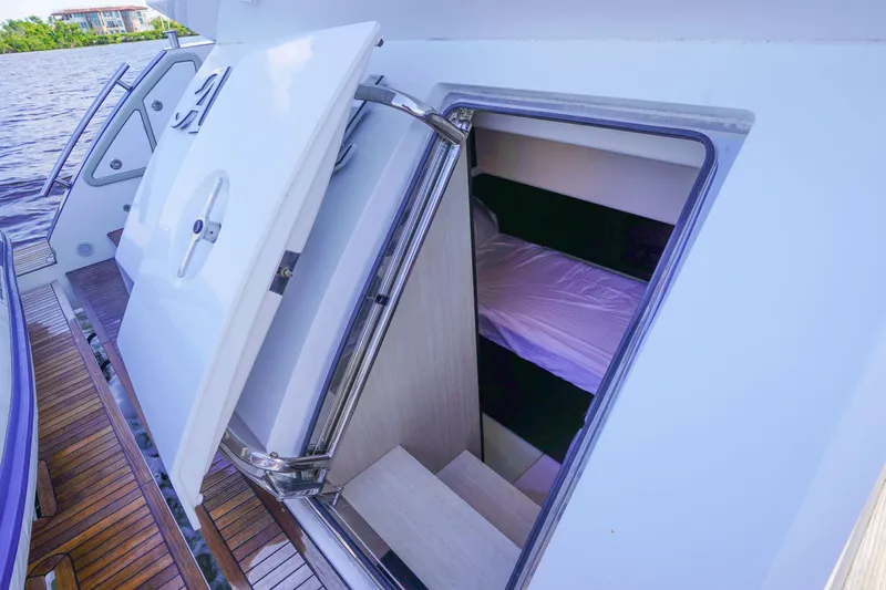 Slide: The Image of 2017 Azimut 66 Flybridge yacht cabin entrance with open hatch and visible interior. - 66