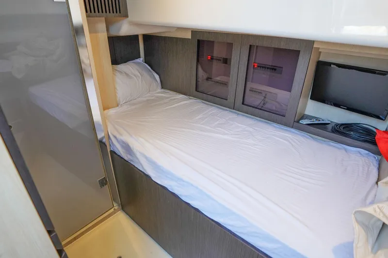 Slide: The Image of Cozy cabin interior of 2017 Azimut 66 Flybridge yacht with single bed and TV. - 67