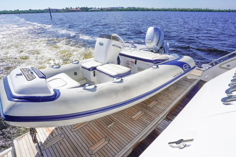Slide: The Image of Azimut 66 Flybridge 2017 yacht with inflatable boat on deck, cruising on open water. - 7