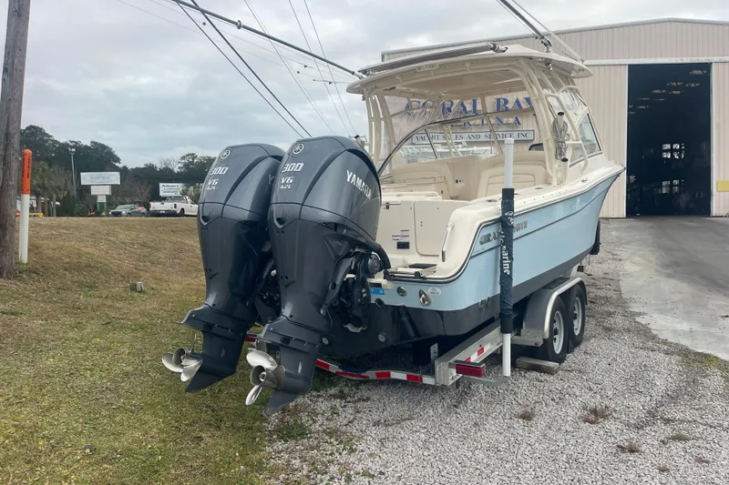 Slide: The Image of 2023 Grady-White Freedom 285 boat with dual Yamaha V6 engines on a trailer. - 13