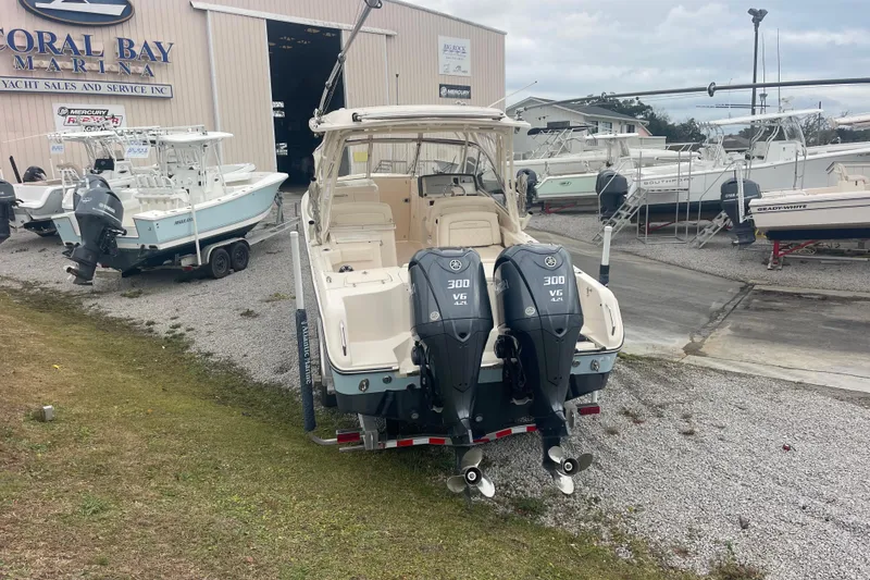 Slide: The Image of 2023 Grady-White Freedom 285 boat with dual Yamaha engines at a marina. - 14