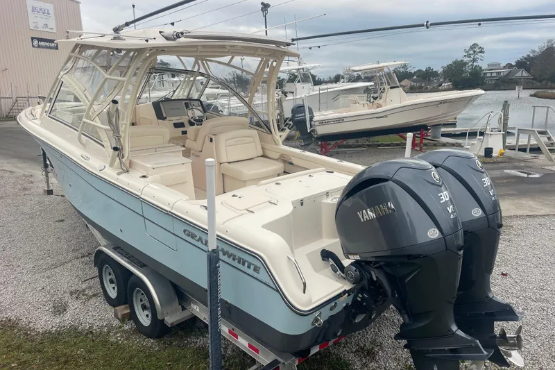 Slide: The Image of 2023 Grady-White Freedom 285 boat with dual Yamaha engines on a trailer. - 16