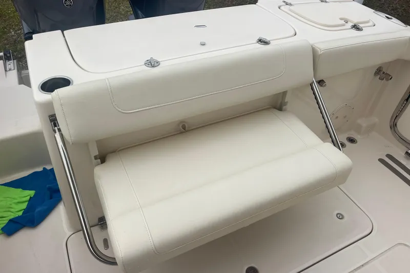 Slide: The Image of 2023 Grady-White Freedom 285 boat with white cushioned seating and stainless steel accents. - 24