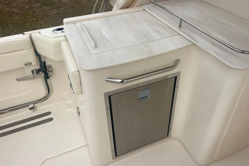 Slide: The Image of 2023 Grady-White Freedom 285 boat interior with sleek cabinetry and stainless steel accents. - 26