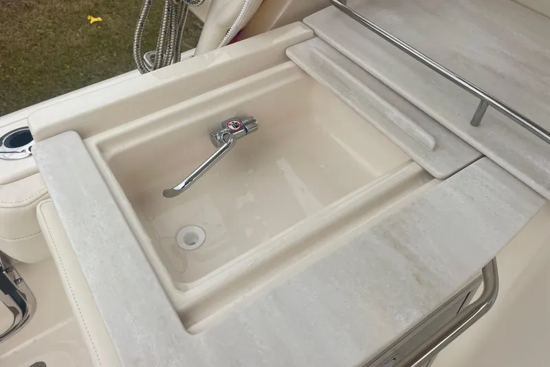 Slide: The Image of 2023 Grady-White Freedom 285 boat sink with chrome faucet and countertop. - 27