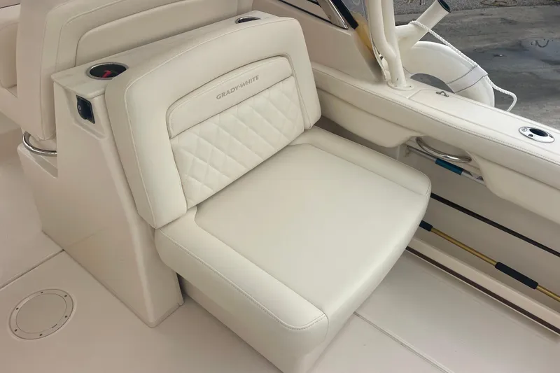 Slide: The Image of 2023 Grady-White Freedom 285 boat seat with elegant white upholstery and cup holder. - 28