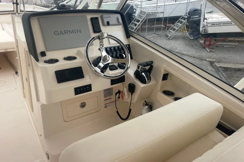 Slide: The Image of 2023 Grady-White Freedom 285 boat helm with Garmin navigation system and steering wheel. - 29