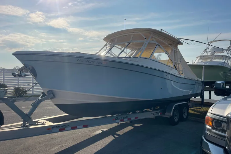 Slide: The Image of 2023 Grady-White Freedom 285 boat on trailer under sunny sky. - 3