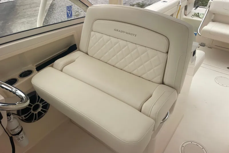 Slide: The Image of 2023 Grady-White Freedom 285 boat interior with luxurious seating and steering wheel. - 37