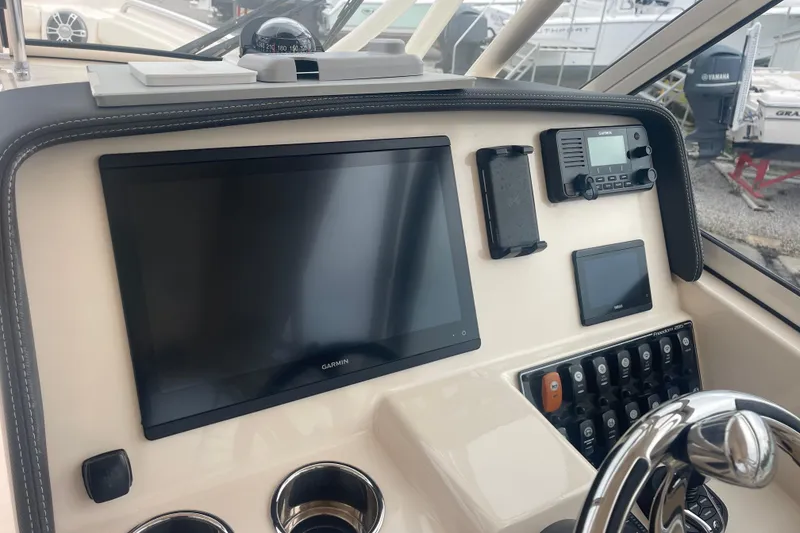 Slide: The Image of 2023 Grady-White Freedom 285 dashboard with Garmin navigation and control systems. - 38