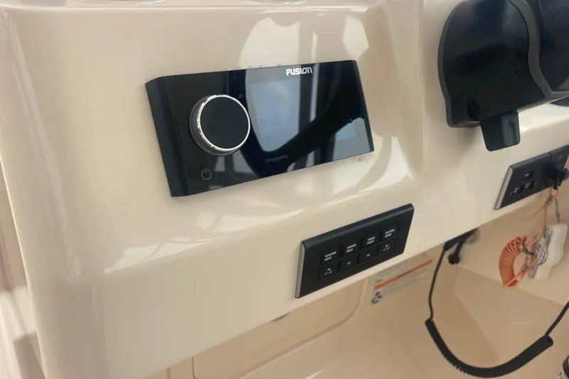 Slide: The Image of 2023 Grady-White Freedom 285 boat dashboard with Fusion audio system and control panel. - 39
