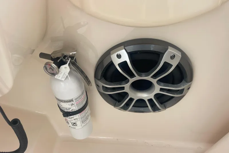 Slide: The Image of Fire extinguisher and speaker on 2023 Grady-White Freedom 285 boat interior. - 43
