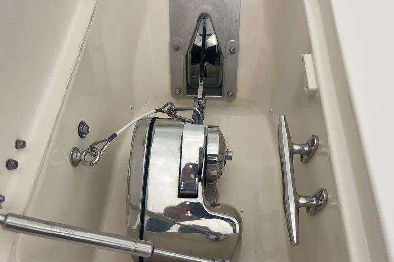 Slide: The Image of Anchor winch system on 2023 Grady-White Freedom 285 boat, featuring polished metal components. - 56