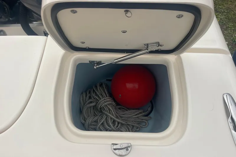 Slide: The Image of Storage compartment on 2023 Grady-White Freedom 285 boat with rope and red buoy. - 63
