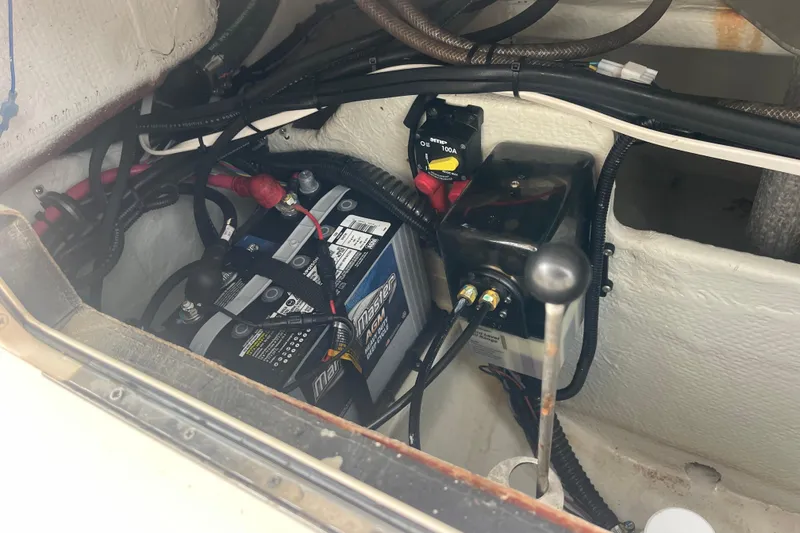 Slide: The Image of 2023 Grady-White Freedom 285 boat battery compartment with wiring and components. - 65