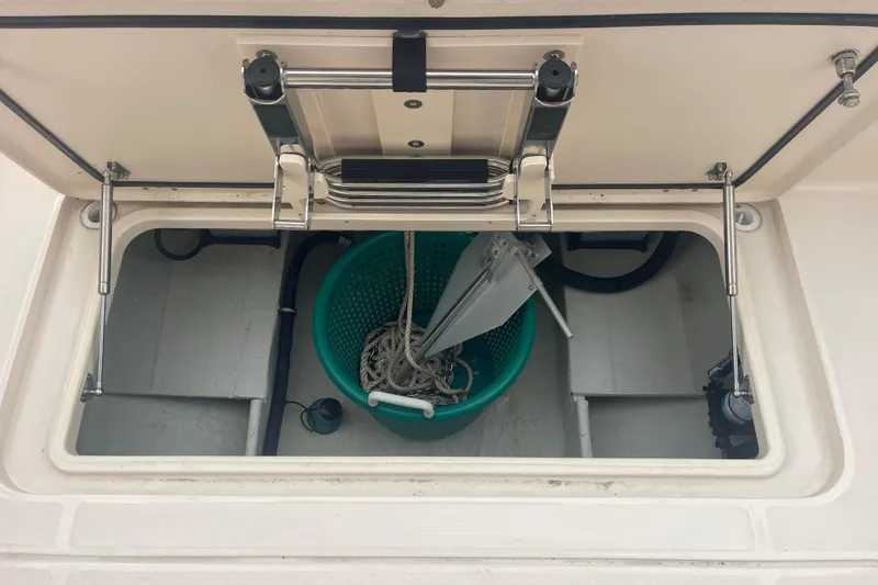 Slide: The Image of Storage compartment of 2023 Grady-White Freedom 285 boat with anchor and rope. - 68