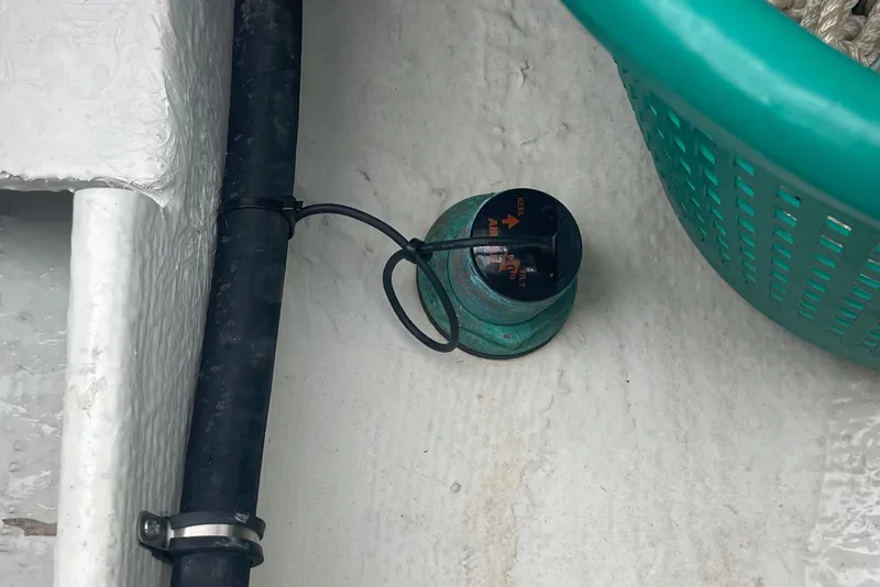 Slide: The Image of Bilge pump and hose on 2023 Grady-White Freedom 285 boat deck. - 69