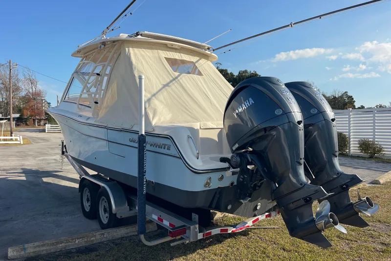 Slide: The Image of 2023 Grady-White Freedom 285 boat with twin Yamaha engines on a trailer. - 7