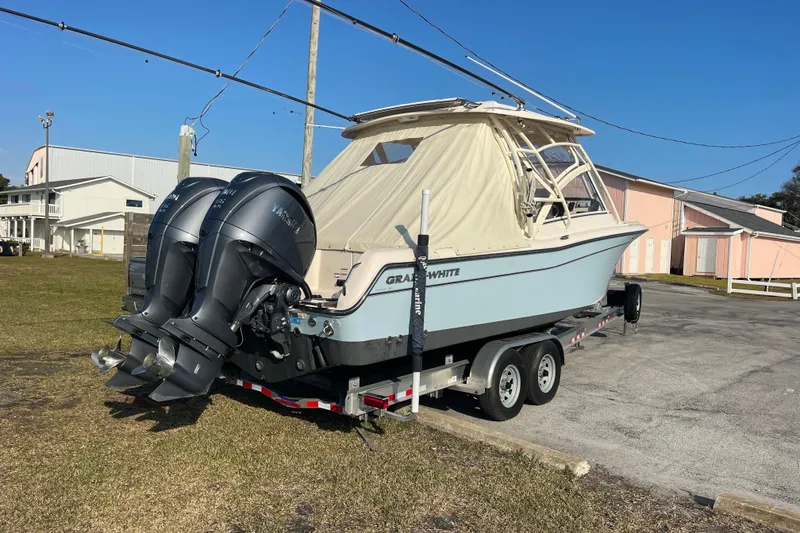 Slide: The Image of 2023 Grady-White Freedom 285 boat on trailer with dual Yamaha outboard engines. - 8