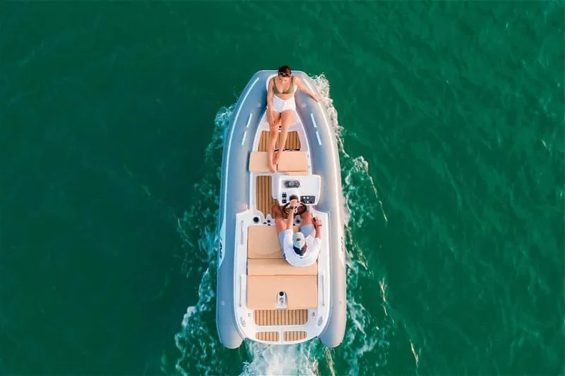 Slide: The Image of 2026 AB Inflatables ABJET 390XP cruising on clear turquoise water, aerial view. - 4