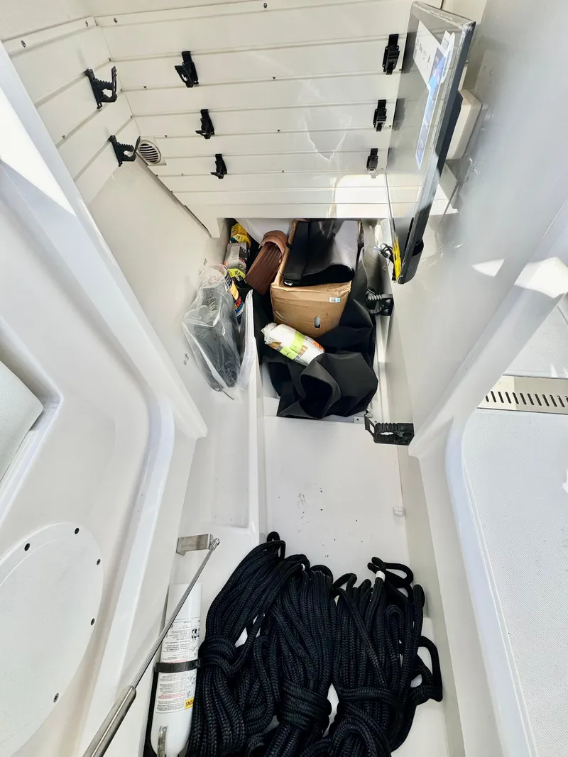 Slide: The Image of Storage compartment of 2025 Tiara Yachts 34 LX with ropes and equipment. - 18