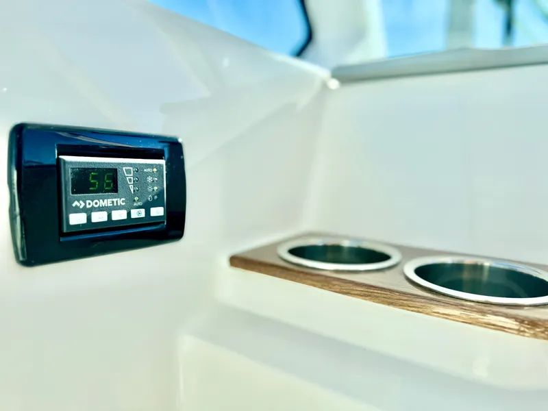 Slide: The Image of Tiara Yachts 34 LX 2025 interior with Dometic control panel and cup holders. - 34