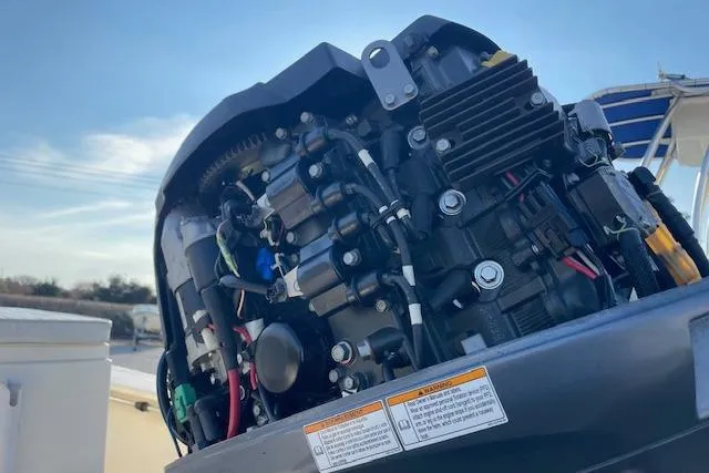 Slide: The Image of Close-up of a 2019 Jones Brothers 17 BATEAU boat engine under a clear sky. - 7