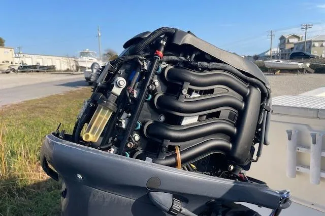 Slide: The Image of Open engine of a 2019 Jones Brothers 17 BATEAU boat, showcasing intricate components. - 8