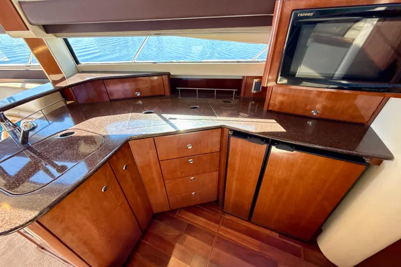 Slide: The Image of Luxurious 2009 Meridian 391 Sedan yacht kitchen with wood cabinetry and modern appliances. - 11