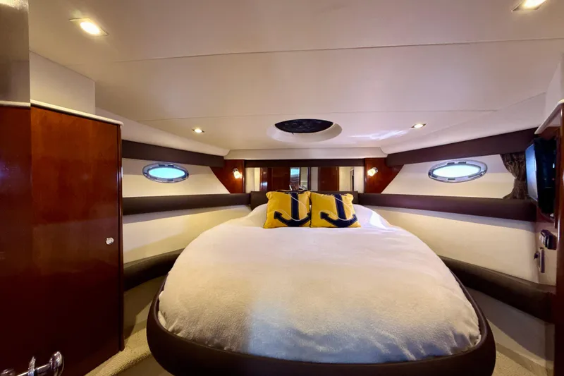 Slide: The Image of Luxurious 2009 Meridian 391 Sedan yacht bedroom with plush bedding and nautical decor. - 15