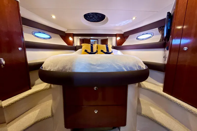 Slide: The Image of Luxurious 2009 Meridian 391 Sedan yacht bedroom with elegant wood finishes and cozy bedding. - 16