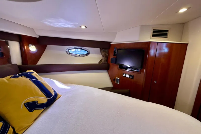 Slide: The Image of Luxurious interior of 2009 Meridian 391 Sedan yacht with cozy bed and TV. - 17