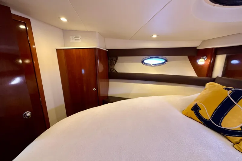 Slide: The Image of Luxurious cabin interior of 2009 Meridian 391 Sedan yacht with porthole and anchor-themed pillow. - 18