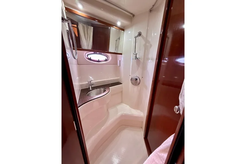 Slide: The Image of 2009 Meridian 391 Sedan yacht bathroom with shower, sink, and wooden accents. - 19