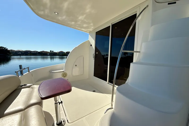 Slide: The Image of 2009 Meridian 391 Sedan yacht interior with seating, table, and water view. - 33