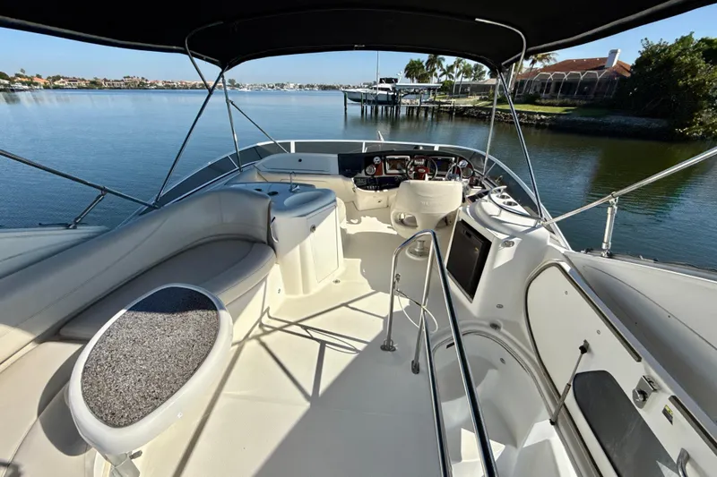 Slide: The Image of 2009 Meridian 391 Sedan yacht cockpit with seating, helm, and waterfront view. - 39