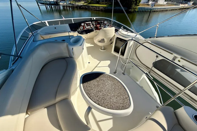 Slide: The Image of 2009 Meridian 391 Sedan yacht interior with helm, seating, and table on calm water. - 40