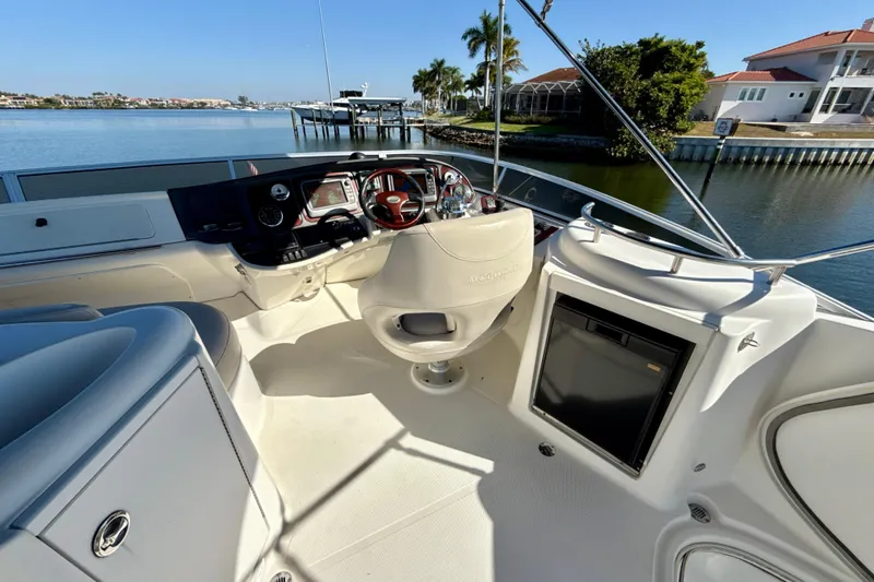 Slide: The Image of 2009 Meridian 391 Sedan yacht cockpit with steering wheel, controls, and waterfront view. - 41