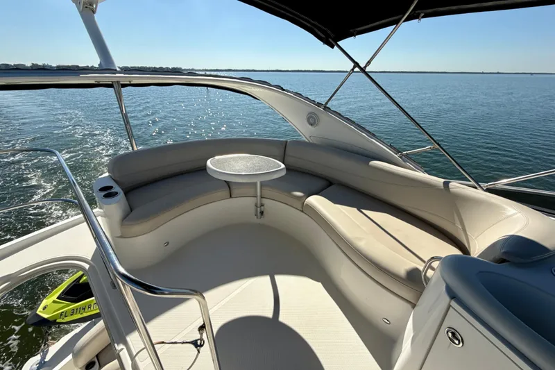 Slide: The Image of 2009 Meridian 391 Sedan yacht interior with curved seating and table on open water. - 47
