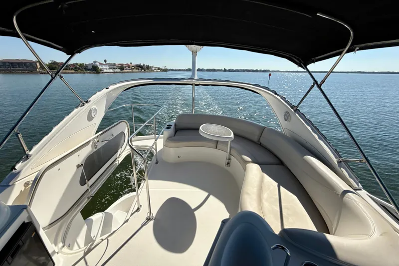 Slide: The Image of 2009 Meridian 391 Sedan boat interior with seating, table, and water view. - 48