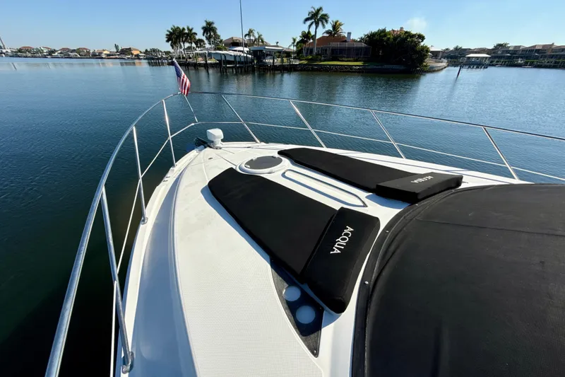 Slide: The Image of 2009 Meridian 391 Sedan yacht on calm water with sunbathing pads and American flag. - 51