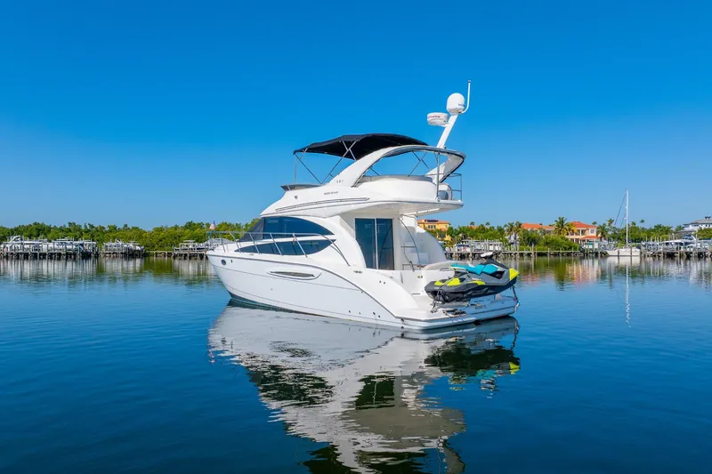 Slide: The Image of 2009 Meridian 391 Sedan yacht on calm water with clear blue sky. - 56