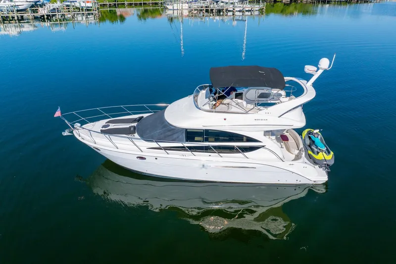 Slide: The Image of 2009 Meridian 391 Sedan yacht on calm water, featuring sleek design and luxury amenities. - 58