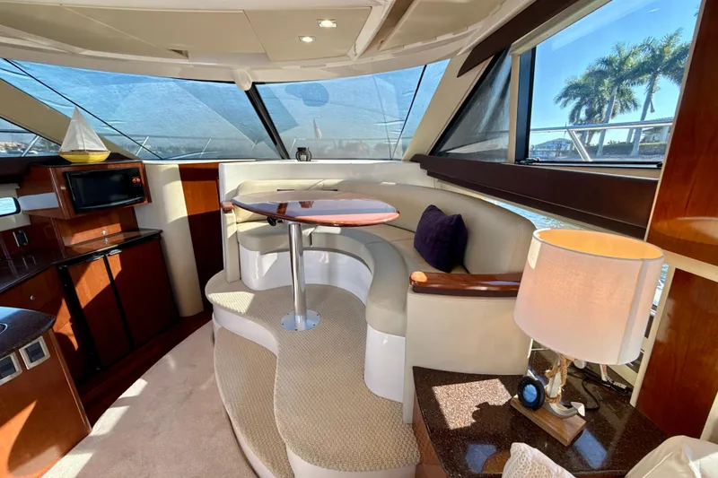 Slide: The Image of Luxurious interior of a 2009 Meridian 391 Sedan yacht with elegant seating and large windows. - 8