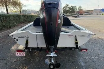Slide: The Image of 2021 Tracker Pro Team 190 TX Tournament Edition boat, rear view with motor, parked outdoors. - 5