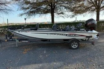 Slide: The Image of 2021 Tracker Pro Team 190 TX Tournament Edition boat on trailer, parked outdoors. - 6