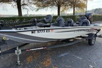 Slide: The Image of 2021 Tracker Pro Team 190 TX Tournament Edition boat on trailer, parked outdoors. - 8