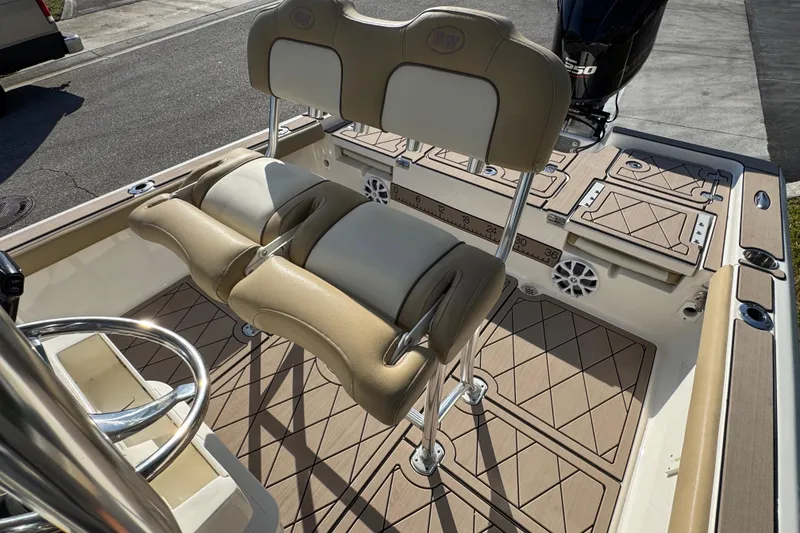 Slide: The Image of 2019 Key West 230 Bay Reef boat interior with tan seating and deck. - 101